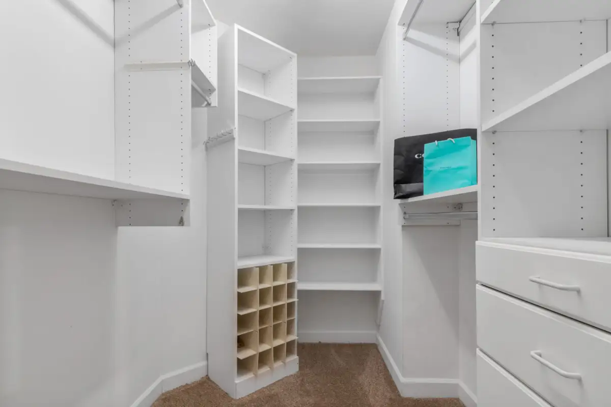 White closet system shelving with drawers and shoe storage cubbies