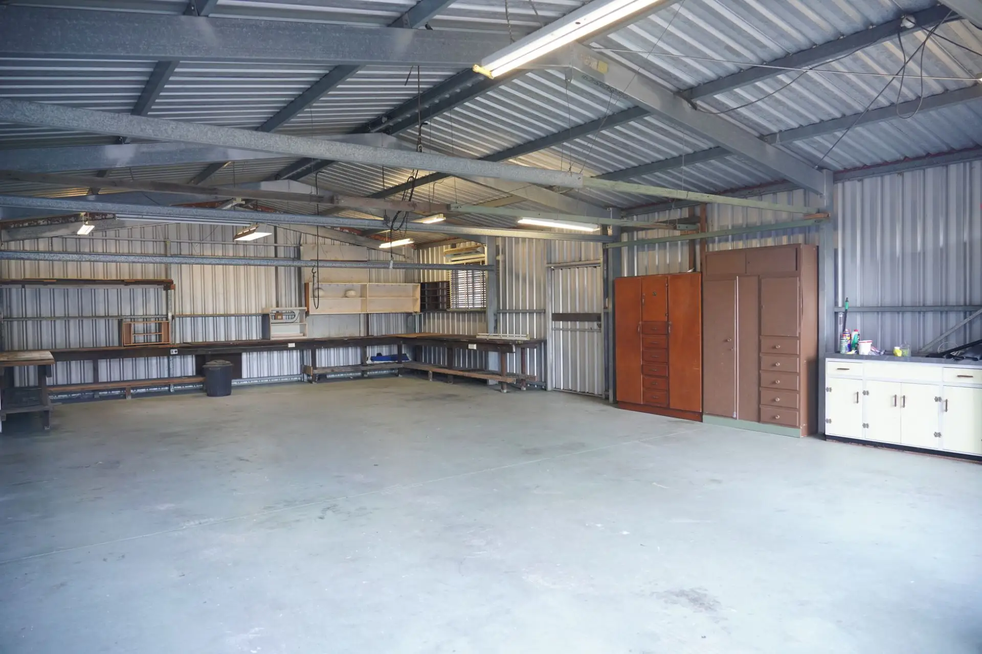 Spacious garage interior with built-in storage cabinets and a workbench
