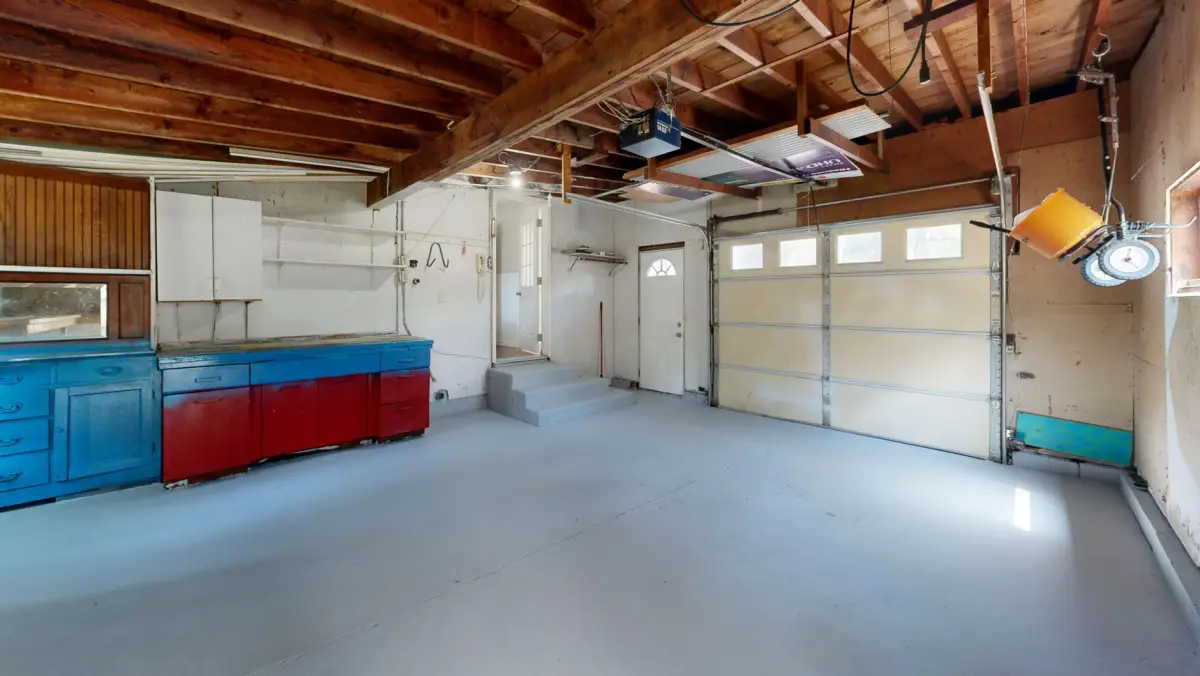 Garage storage cabinets with drawers next to an open workspace