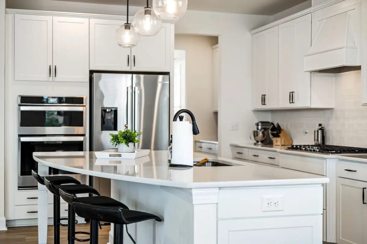 Custom kitchen island cabinetry with built-in storage and a wood countertop