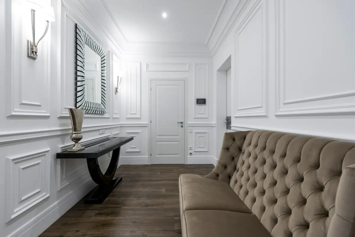 Hallway with raised-panel wainscoting, crown molding, and picture-frame trim