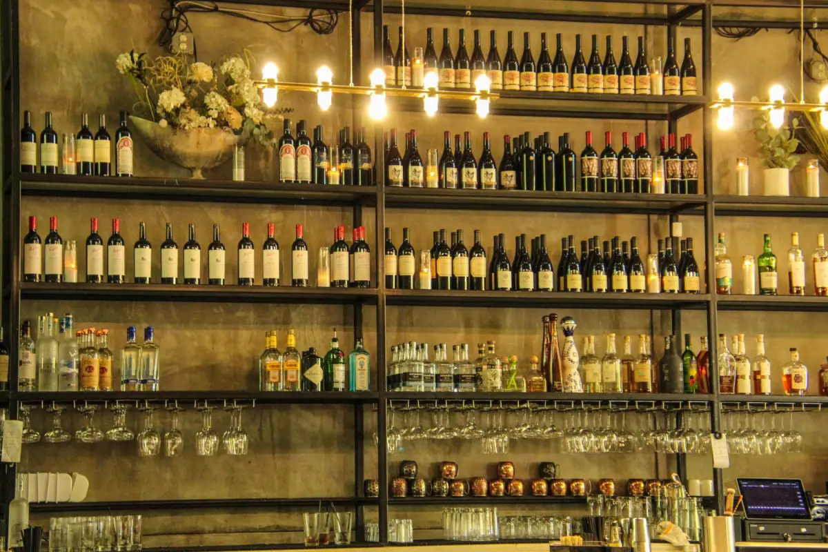 Restaurant back-bar shelving stocked with wine and liquor bottles