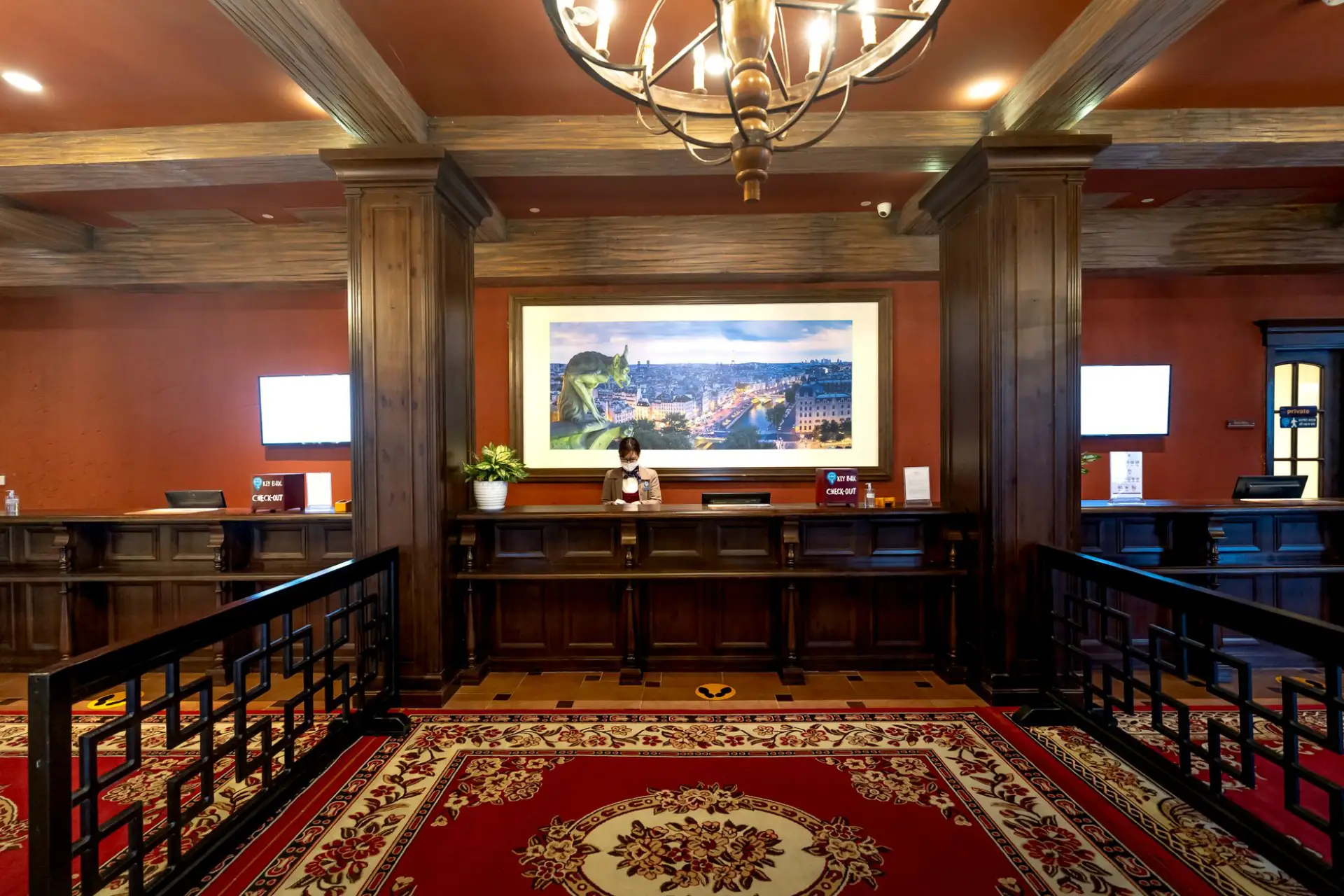 Elegant hotel lobby front desk with dark wood millwork and warm lighting