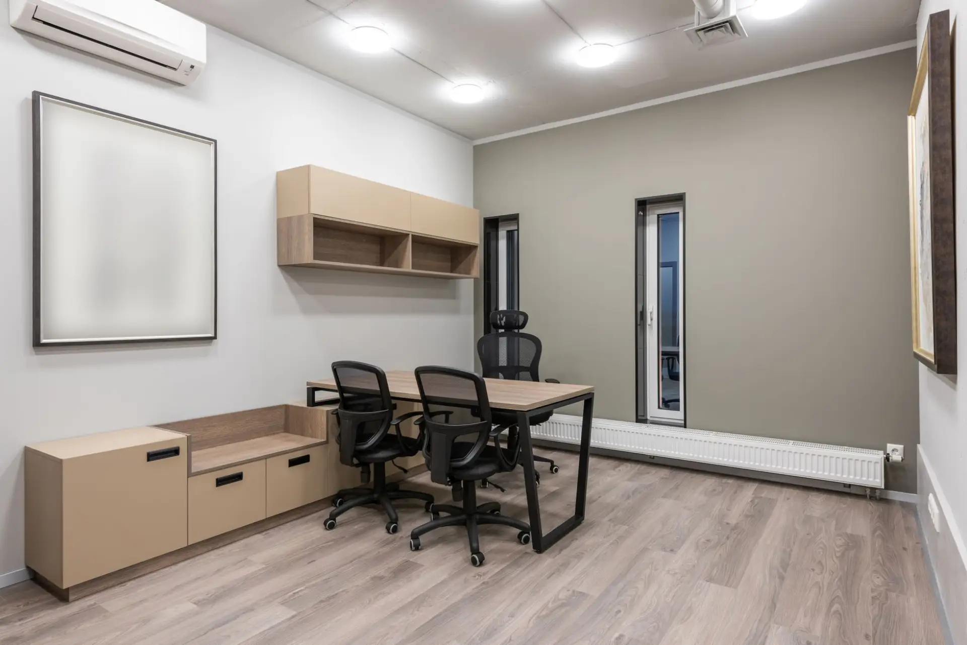 Modern private office with built-in wood wall cabinetry and storage